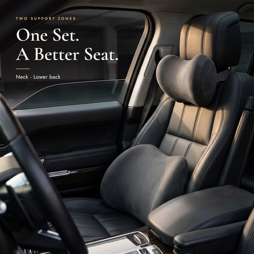 Neck pillow on the headrest and lumbar pillow on a black leather car seat