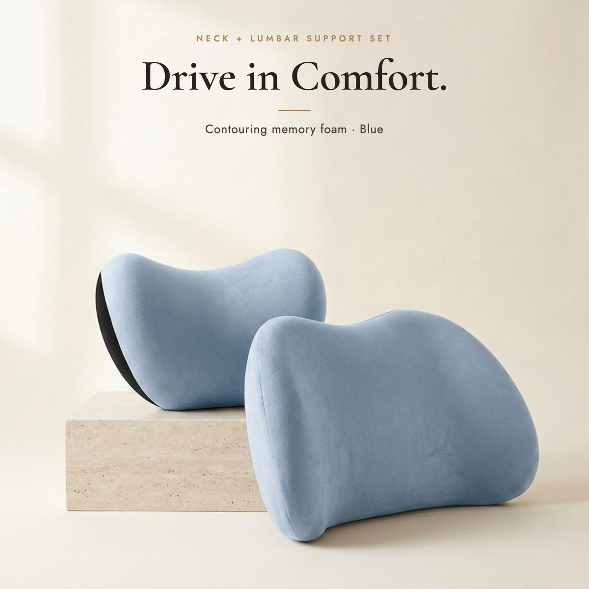 Blue neck pillow and lumbar pillow on an ivory background
