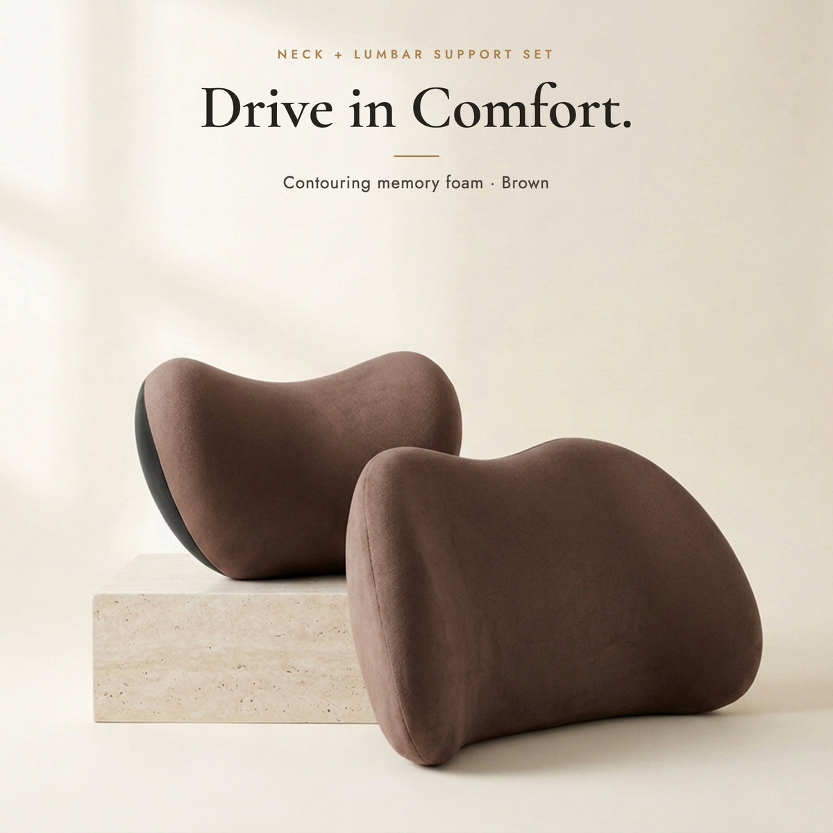 Brown neck pillow and lumbar pillow on an ivory background
