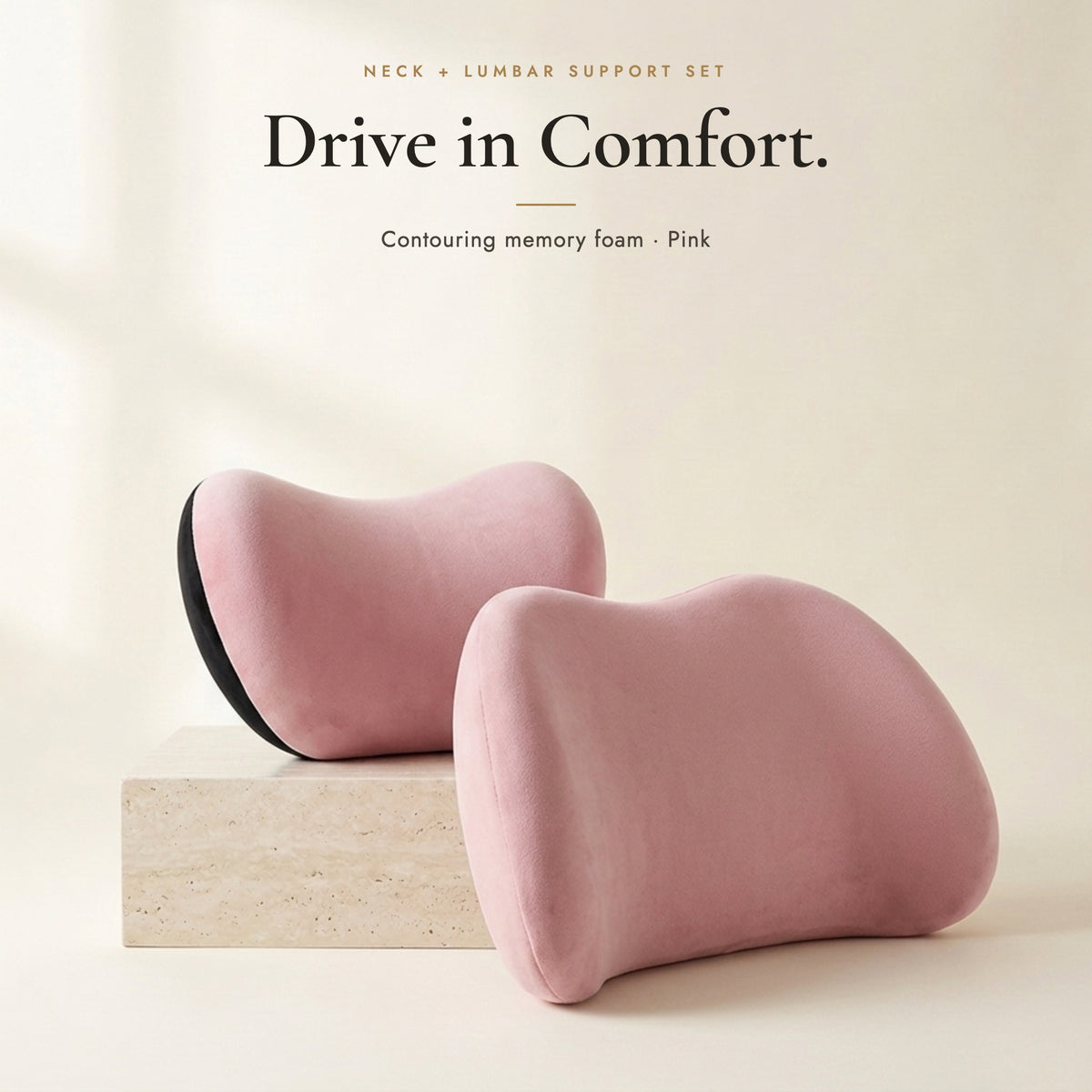 Pink neck pillow and lumbar pillow on an ivory background