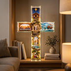 Lighted Jesus story cross on a living room bookshelf in the evening